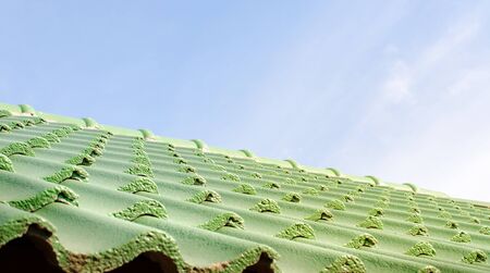 Green roof tile pattern over blue sky, Selective and Soft focusの写真素材