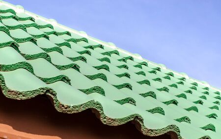 Green roof tile pattern over blue sky, Selective and Soft focusの写真素材