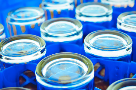 Selective focus, Empty water glasses arranged in blue plastic boxの写真素材