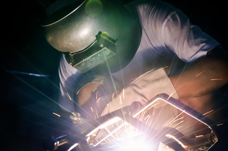 Color effect and selective focus of welder working in workshop
