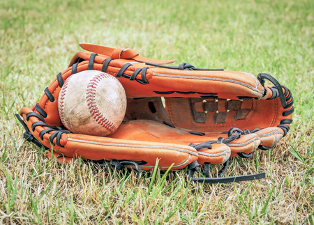 Nostalgic baseball in glove on a baseball field, Close up imageの写真素材