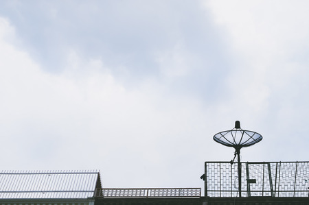 Vintage look filter with place for your text, Home satellite dish with blue skyの写真素材