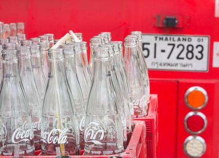 BANGKOK, THAILAND - JUNE 25: Empty recycle bottles of Coca Cola in red plastic box on June 25, 2016 in Bangkok, Thailand. Coca Cola drinks are produced and manufactured by The Coca-Cola Companyのeditorial素材