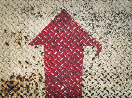 Color retro image, Red Arrow Signs on grungy old weathered metal diamond plate with scratch and dirty, Used for textured and backgroundの写真素材
