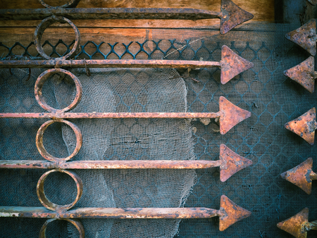 Rusty metal fence with sharp arrows, Used for textured and background, Image has a vintage effect applied.の写真素材
