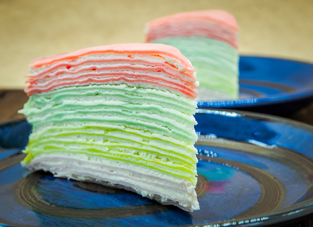 Rainbow vanilla crepe cake on wooden background, food imageの写真素材