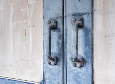 Blue steel door handles of the old wooden door, With place your text (door, handle, vintage)の写真素材