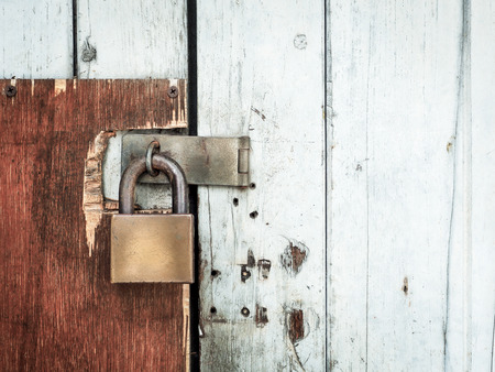 Old lock on a wooden door, With place your text (lock, rust, security)の写真素材