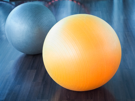 Color filter image, Fitness rubber balls on parquet floor (fitness, ball, yoga)の写真素材