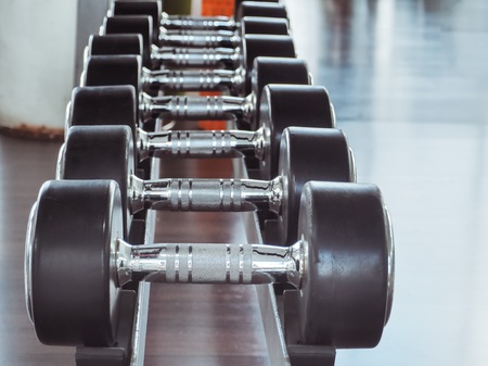 Dumbbell in at the gym room /Color filter and selective focusの写真素材