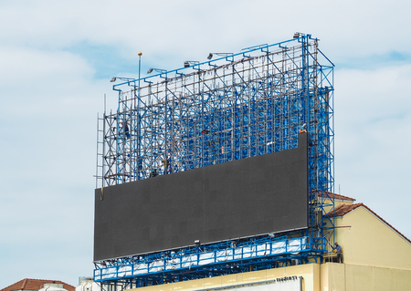 Group of workers are climbing poles to install LED billboards. Bangkok, Thailand on October 24 , 2016のeditorial素材