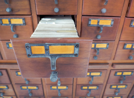Open wooden boxes with index cards in library, Selective focus and Close up imageの写真素材
