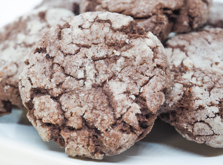 Chocolate with almond cookies in powdered sugar on white backgroundの写真素材