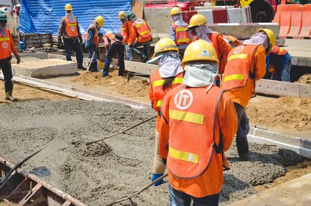 BANGKOK: MAY 13, Concrete pouring work during road concreting floors in construction on May 13,...