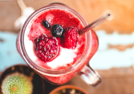 Mixed berry (Raspberry, strawberry and blueberry) with yogurt smoothie, Selective focus and Close up imageの写真素材