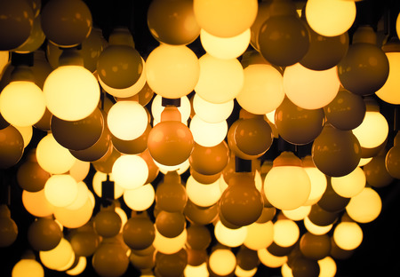 Lighting ball hanging from the ceiling on the black background