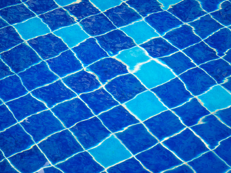 Background of rippled water in swimming pool / Blue ripped water in swimming pool