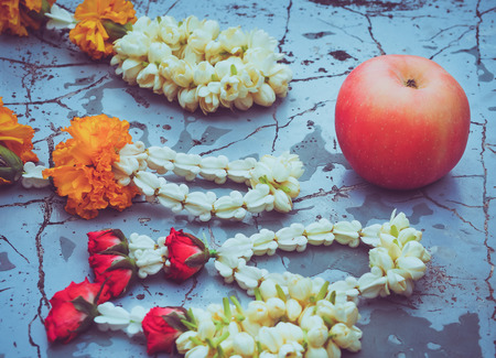 Flower garlands and apple fruit for buddhism religious ceremony, Thailandの写真素材