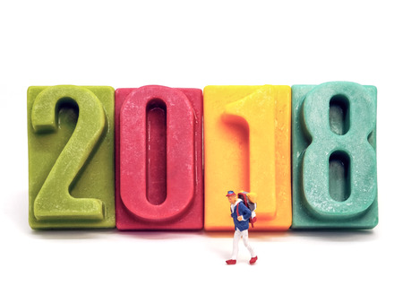 Miniature people: Travelers walk on front of number 2018, For Happy new years concept.の写真素材