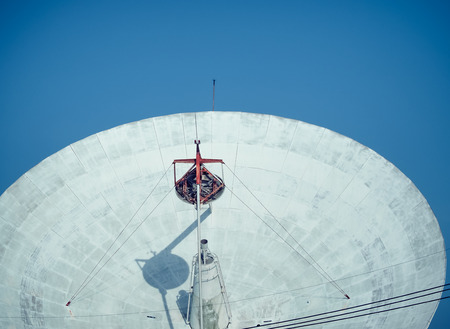 Satellite dish at earth station with a blue sky in the backgroundの写真素材