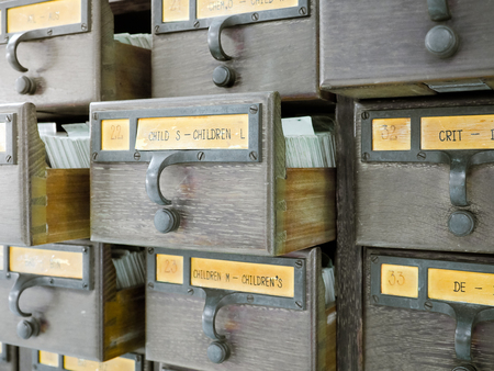 Open wooden boxes with index cards in library, Tag Content is "CHILDREN". Selective focus and Close up imageの写真素材