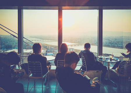 Osaka, Japan - April 3, 2017: Umeda Sky Building, Floating Garden Observatory. The tourists sit and watch the sunset on the top floor of the building. Umeda Sky Building is popular landmark in Osaka, Japanのeditorial素材