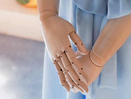 Close up of hands wooden dummy model in The female dress screenings. Retro filter. Image for beauty and fashion concept.の写真素材