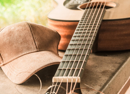 The bridge of an acoustic guitar with a cloth cap in country style. Selective focus and close up.の写真素材
