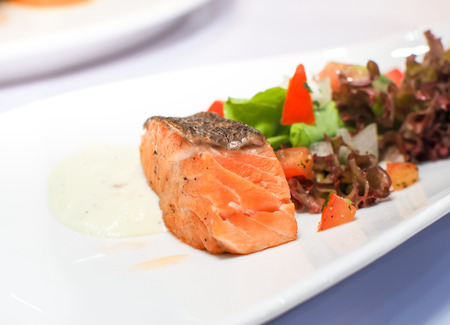 Salmon steak served on white plates. Food image.の写真素材