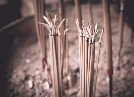 Selective focus on front of josssticks, Incense sticks are burning with smoke use for pay respect to the Buddhaの写真素材