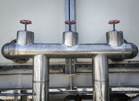 Gas pipeline valve and gas pressure control on a wall.