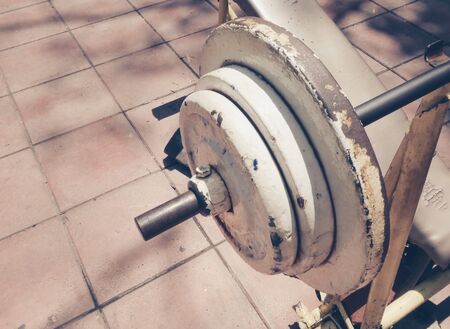 Close up of old barbell or dumbbell. Outdoor view in the park (healthcare, sport, fitness)の写真素材