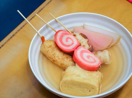 Oden stick fish and tamago egg with hot soup on wooden table, Japanese food gourmet.の写真素材