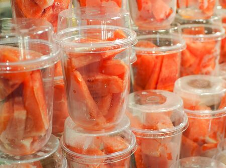 Pieces of fresh watermelon placed in plastic glasses ready for blender. Fruits drink Smoothies frosty. Healthy food.の写真素材