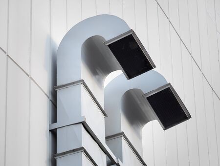 Ventilation and air conditioning pipe installed outside the building. Ventilation tube for construction building or factory.の写真素材