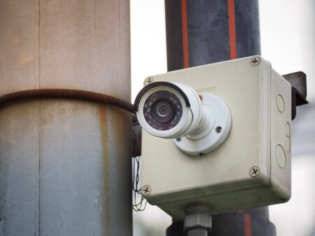 CCTV security camera on a high pole for public protection. Surveillance CCTV in the city.の写真素材