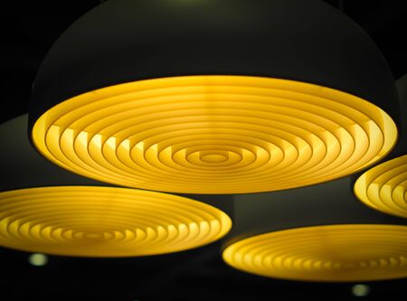 Selective focus of geometric circular ceiling lights in the dark. Abstract background.の写真素材