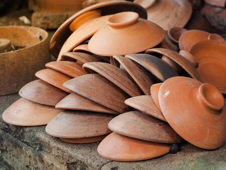 Dark brown ceramic clay pottery. Traditional handmade pottery bowl. Thailand.の写真素材