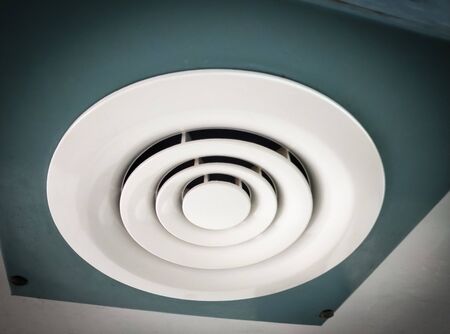 Air Ventilating tube installed on the ceiling of the office building. Close up and selective focus.の写真素材
