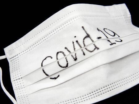Coronavirus Covid-19, Close-up of medical mask on a black background. Virus protection mask.の写真素材