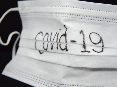 Coronavirus Covid-19, Close-up of medical mask on a black background. Virus protection mask.の写真素材