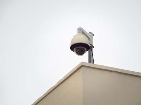 CCTV security camera on a high pole for public protection. Surveillance CCTV in the city on white background.の写真素材