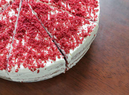 Homemade red velvet cake on wooden table. Traditional american dessert.