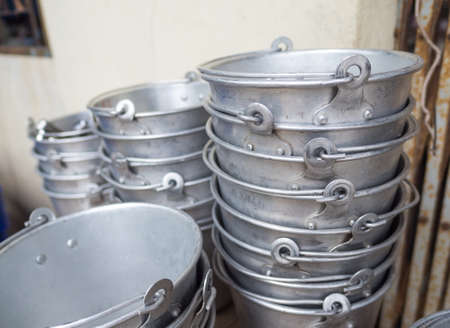 Many old aluminum ice bucket laid in wait for use.の写真素材