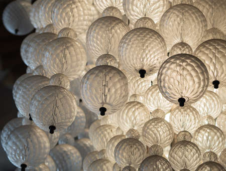 Glowing light bulb hanging from the ceiling hall background. Interiors objects.の写真素材
