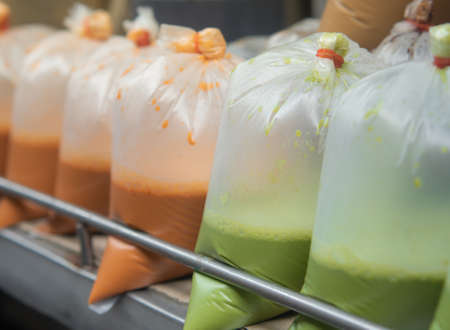 Hot thai tradition coffee, Hot thai tea, and Hot milk green tea in plastic bags ready for sale in the street market. Bangkok. Thailand.の写真素材