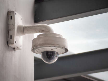 Old CCTV camera security on the cement wall. CCTV for security monitoring.