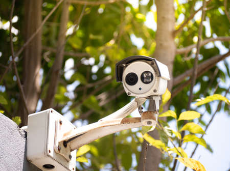 Old CCTV security camera on a high pole for public protection. Surveillance CCTV in the city.