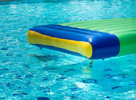Colorful rubber rafts floating in the swimming pool.の写真素材