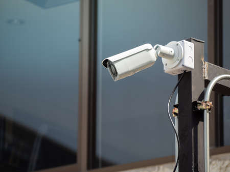 CCTV camera security on the pole in the car parking. (security, safety, technology)